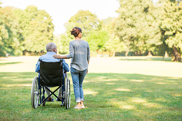 A carer with a person in a wheelchair